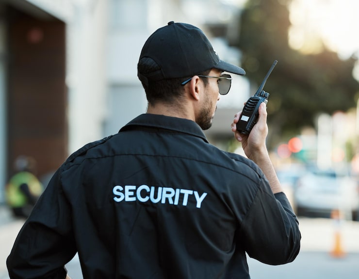 EyeQ security officer using a radio on duty